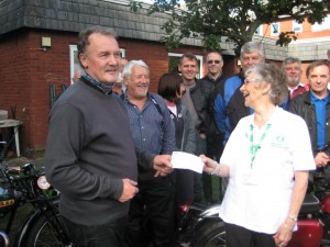 Alex presenting Cheque for £250 to Macmillan Rep 18th Sept' 2011